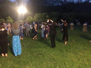 a group of people dancing in the grass at night at Sarikonaklar Garden Village in Sile +67 photos