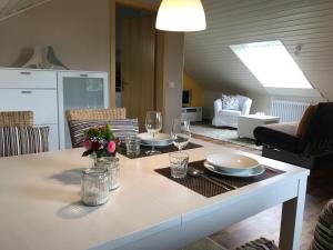 a living room with a table with plates and glasses at Ferienwohnung Salem-Beuren in Beuren