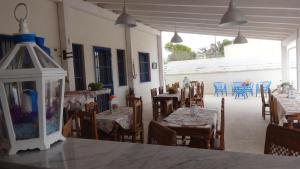 a dining room with tables and chairs and a room with tables and chairsktop at B&B Giorgio La Pira in Santa Maria del Focallo