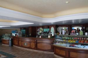 a bar in a restaurant with a lot of alcohol at Hotel Villaggio Club Altalia in Brancaleone Marina