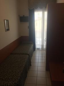 Posteľ alebo postele v izbe v ubytovaní Hotel Lido