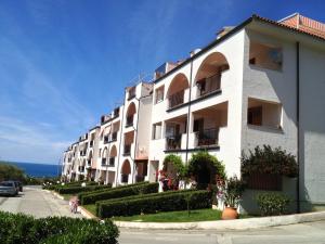 a row of apartment buildings on a street at Uliveto in Gioiosa Marea