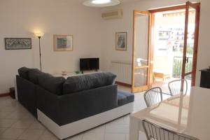 a living room with a couch and a table at Uliveto in Gioiosa Marea