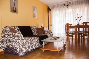 a living room with a couch and a table at La Oliva Noja in Noja