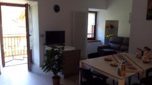 モルヴェーノにあるPaganella Apartmentのリビングルーム(ソファ、テーブル、テレビ付)
