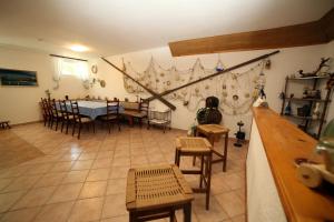 a living room with a table and chairs in a room at Guesthouse Meri in Fažana