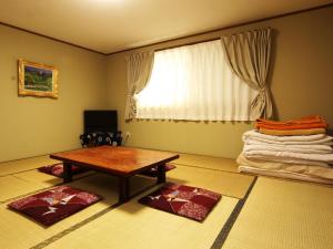 TV a/nebo společenská místnost v ubytování Guesthouse Tomoshibi