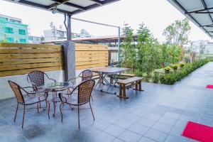 a group of tables and chairs on a patio at Just Stay 稼軒 in Yuanshan