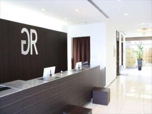 an office with a reception desk in a building at Green Rich Hotel Tosu Ekimae in Tosu