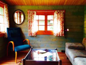 a living room with a couch and a table and a window at Kuivastujaani in Kuivastu