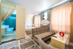 a living room with a couch and a bed at Inn OZZ in Karagandy +111 photos