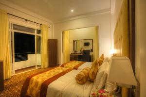 Voodi või voodid majutusasutuse The Queensburry City Hotel toas