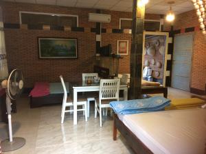 a living room with a table and chairs at Charming Countryside Homestay in Ben Tre