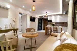 a living room with a couch and a table at The View Hotel Perdika in Perdika