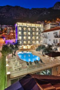 a hotel with a swimming pool in front of a building at Kaş Artemis Hotel in Kas