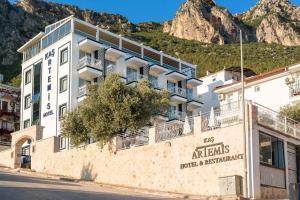 a building in front of a mountain at Kaş Artemis Hotel in Kas