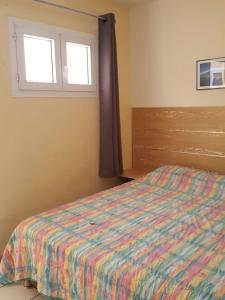 Кровать или кровати в номере Hotel-appart Les Manguiers