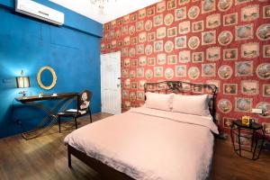 a bedroom with a bed and a wall of plates at Earth Village B&B in Hualien City