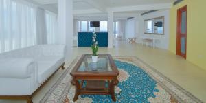 a living room with a couch and a coffee table at Ibiscus Hotel in Rhodes Town