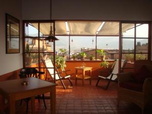 a room with a large window with chairs and a table at Milla Guesthouse Bhaktapur in Bhaktapur