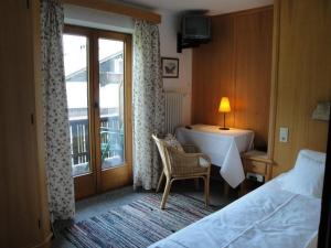 a hotel room with a bed and a balcony at Gästehaus Brindlinger in Zell am Ziller +9 photos