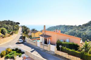 a house on a hill with a street and a road at Can Tapsy in Tossa de Mar