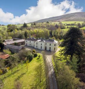 an aerial view of a white house in a field at Clone House Event Villa in Aughrim