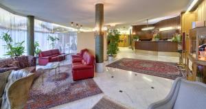 a living room with red furniture and a lobby at Grand Hotel Cravat in Luxembourg +17 photos