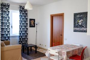 a living room with a table and a couch at Residence Shopping Outlet in Novi Ligure