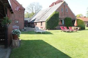 a yard with chairs and tables and a building at Gretes Hof in Osterholz-Scharmbeck