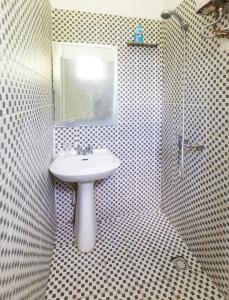 a bathroom with a sink and a mirror at Room With A View & Apartment Style in Port Vila
