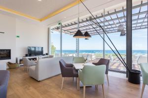 a living room with a view of the ocean at Palmares Beach House Hotel - Adults Only in Lagos