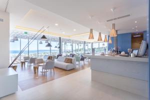 a kitchen and living room with a view of the ocean at Palmares Beach House Hotel - Adults Only in Lagos