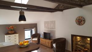 a living room with a table and a television at Casa Corsa in Santa-Lucia-di-Tallano