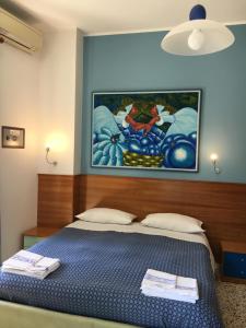 sypialnia z łóżkiem i obrazem na ścianie w obiekcie Piccolo Principe Salerno B&B w mieście Salerno