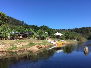 a river with boats parked on the side of it at The Riverdeck Accommodation and Backpackers in Knysna