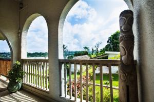 a balcony with arches and a view of a yard at Room With A View & Apartment Style in Port Vila