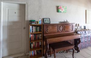 a room with a piano and a book shelf with books at Room With A View & Apartment Style in Port Vila