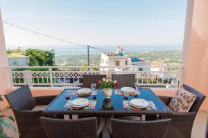 a table and chairs on a balcony with a view at Diogenis Home in Maroulás