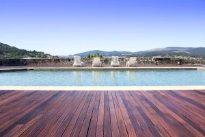 
a swimming pool with a view of the ocean at Boega Hotel in Vila Nova de Cerveira
