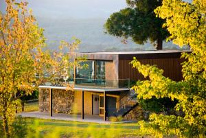 a house on a hill with trees in the foreground at Boega Hotel in Vila Nova de Cerveira