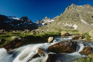 a stream in a mountain valley with mountains in the background at Haus Karin in Sankt Gallenkirch