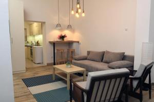 a living room with a couch and a table at Blue Box Apartment in Belgrade