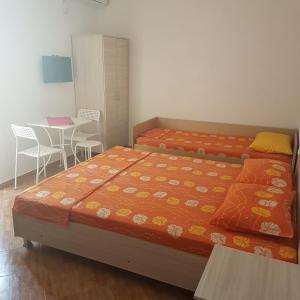 1 dormitorio con 1 cama, mesa y sillas en Apartmani Milica Dojran, en Star Dojran
