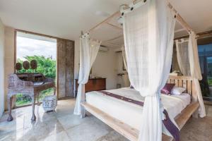 Postel nebo postele na pokoji v ubytování BoHo Hills Bali