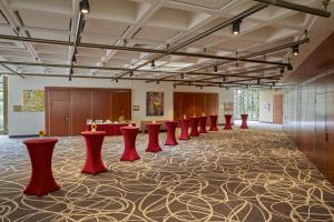 a large room with a row of red stools at Sunday Hotel Bad Soden in Bad Soden am Taunus