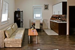 a living room with a couch and a table at Apartments Dujmović in Međugorje