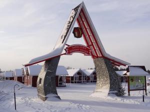 a sculpture in the snow in front of a building at Santa Claus Holiday Village in Rovaniemi