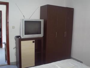 a tv sitting on a stand next to a cabinet at Apartmani Dado in Ulcinj
