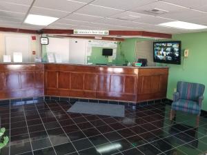 a waiting area of a waiting room with a counter at Americas Best Inn - Savannah I-95 in Savannah